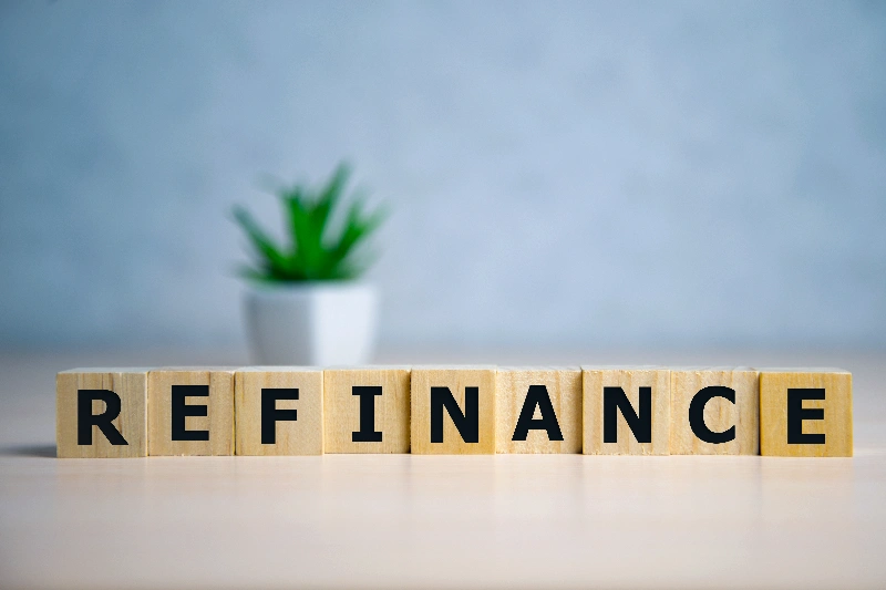 Focus on wooden blocks with letters Refinance text
